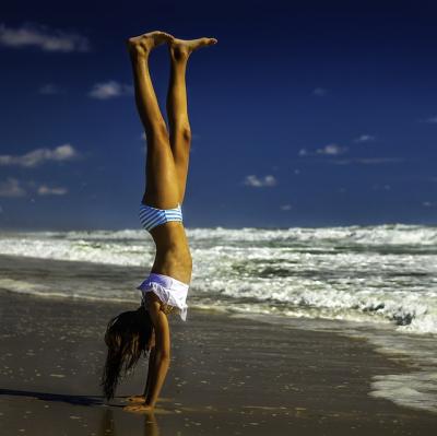 Do a hand-stand on a beach