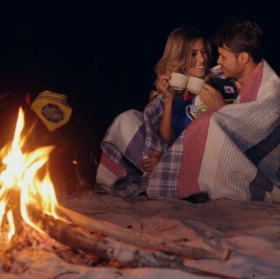 Sit by a campfire on the beach