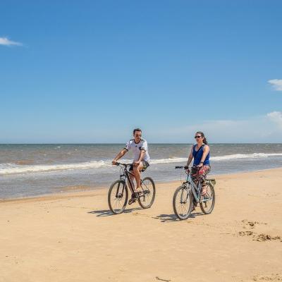 Ride a bicycle along a beach
