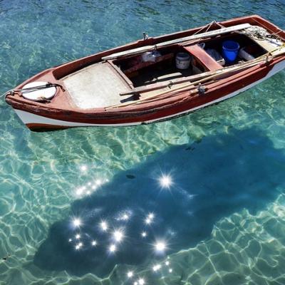Row a boat in crystal clear waters