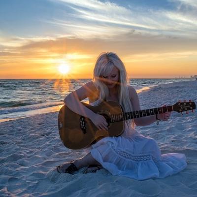 Play a guitar on a beach