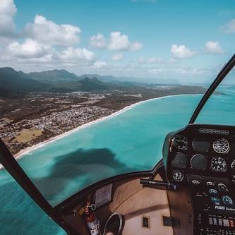 Sit in the front of a helicopter