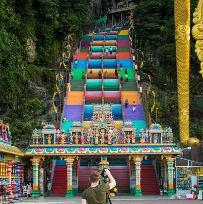 Climb the stairs to the Batu Caves