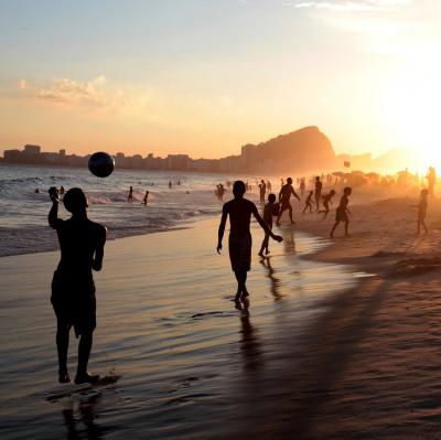Play football on a beach in Brazil